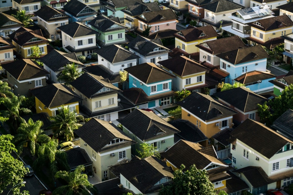 A row of modern, square-shaped houses with different colored exteriors.