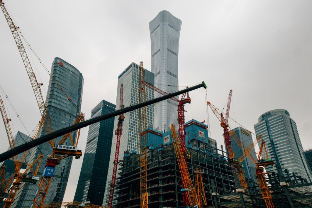 Skyscrapers and cranes in a city under construction.