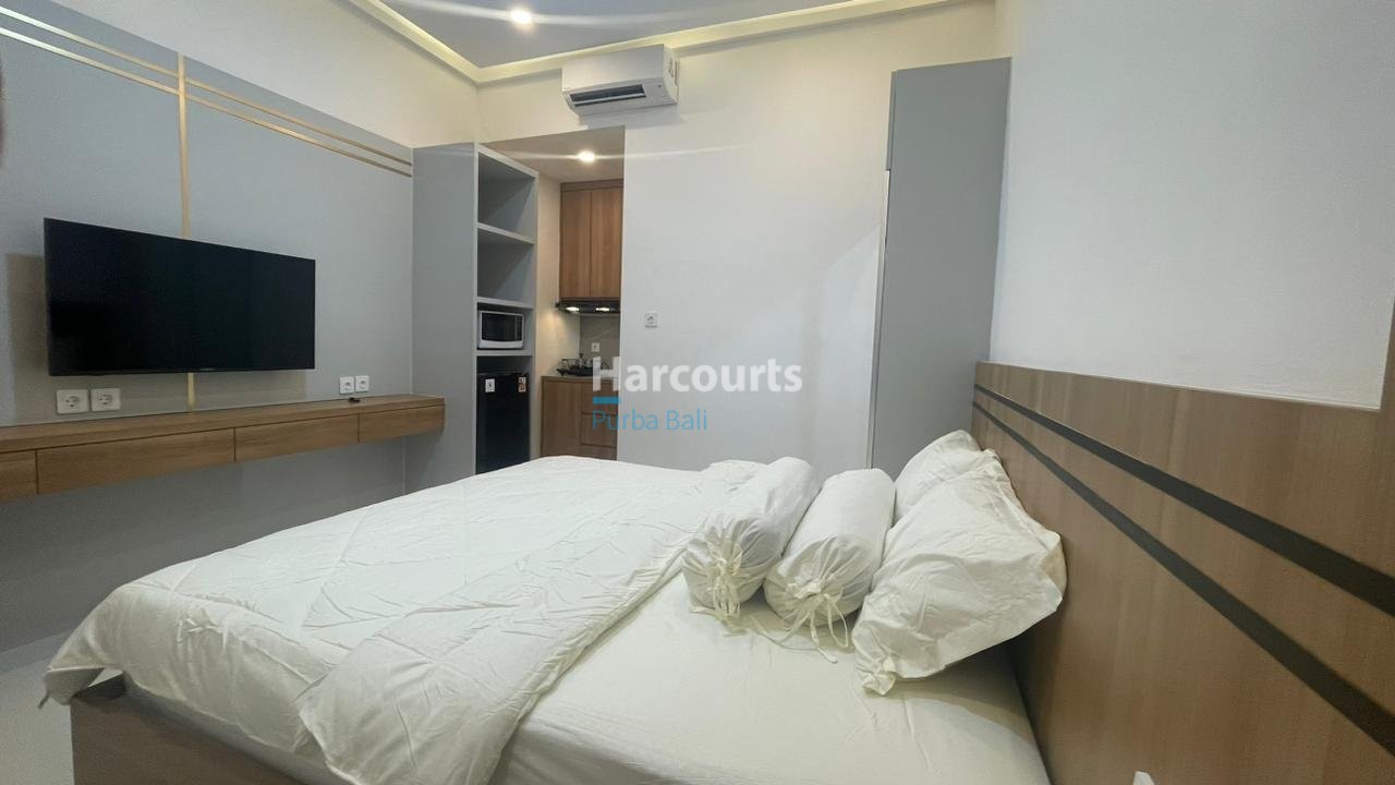 Kuta Leasehold Apartment Wooden Headboard White Bedding