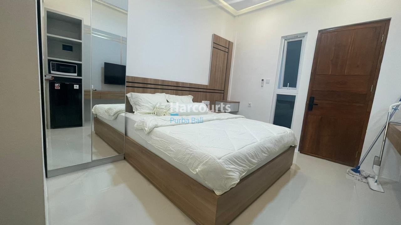 Turnkey Kuta Apartment White Floors Wooden Headboard
